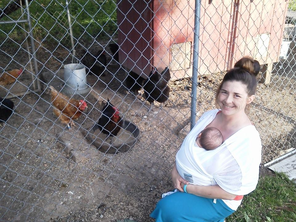 Baby wearing carrier used during daily farm chores